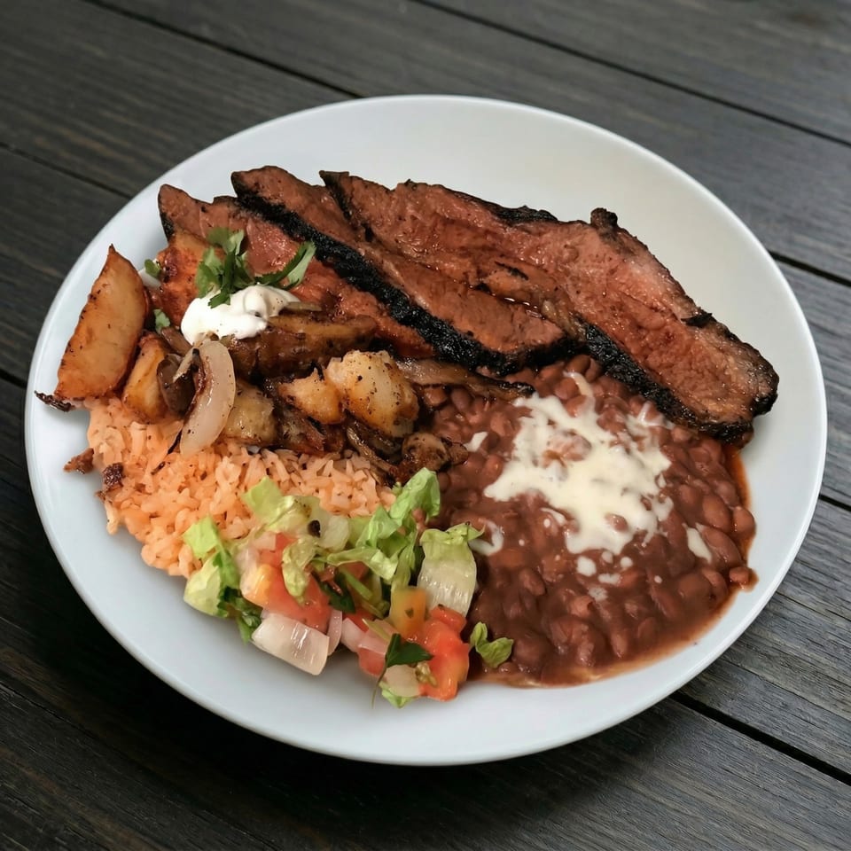 Grilled steak with rice, beans, potatoes, and a side salad on a white plate.